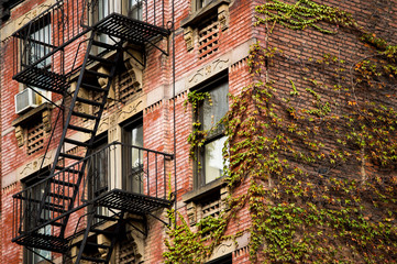 Close-up view of New York City style apartment buildings with emergency stairs along Mott Street in Chinatown neighborhood of Manhattan, New York, United States..