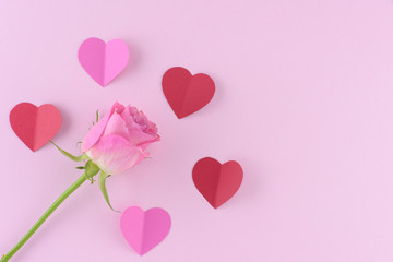 Fototapeta na wymiar Pink rose with hearts, valentine day background