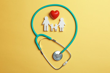 Flat lay composition with heart, stethoscope and family figure on color background. Life insurance...