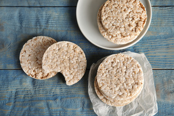 Composition with crunchy rice cakes on wooden background, top view