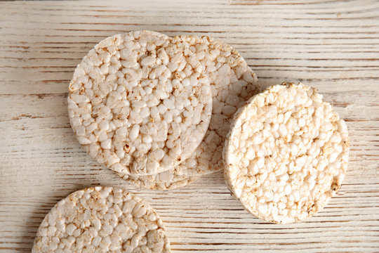 Crunchy rice cakes on wooden background, top view