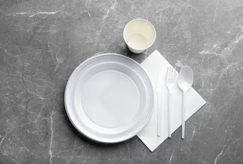Foto op Canvas Composition with plastic dishware on grey background, flat lay. Picnic table setting © New Africa