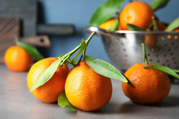Tasty ripe tangerines on table. Citrus fruit
