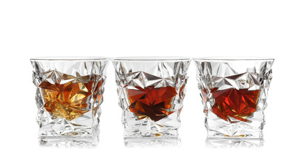 Glasses of scotch whiskey on white background