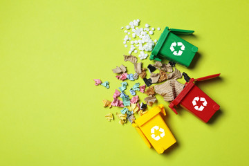 Trash bins and different garbage on color background, top view with space for text. Waste recycling...