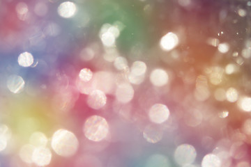 Golden Colorful blurred bokeh lights background. Abstract sparkles particle moving small large...