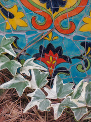 colorful garden mosaic nestled in ivy