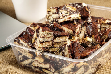 Chocolate brownies with coffee on a rug background.