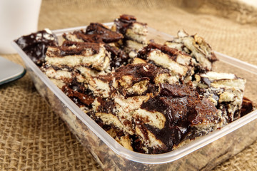 Chocolate brownies with coffee on a rug background.