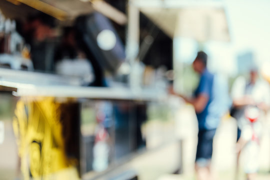 Unfocused image of a man ordering food in a food truck