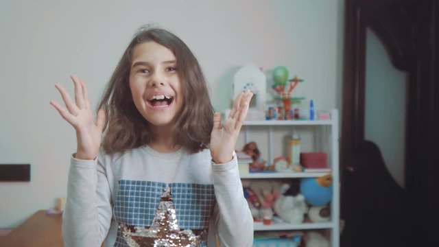 hide and seek. little girl covered her eyes face with her hands peek a boo waiting for a lifestyle surprise. slow motion video. teen girl playing bo-peep. childhood concept game hy - spy