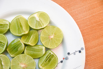 Lime in white dish on wood blackground