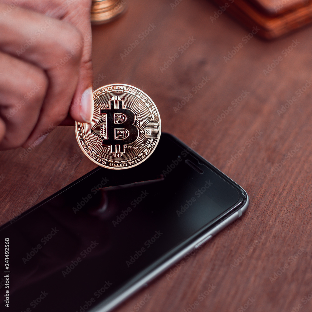 Poster cryptocurrency bitcoin. hand put coin to smartphone. saving and exchange digital money concept.