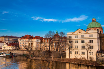 Fototapeta premium Boat on Vltava river at sunset in Prague