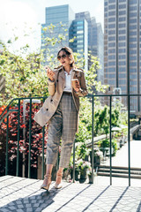 businesswoman outdoor relying against handrail