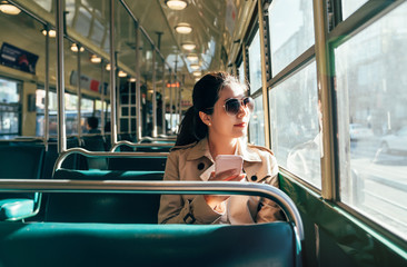 girl using cellphone in public transportation