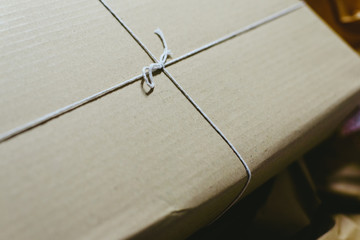Gifts in simple cardboard boxes with white cord