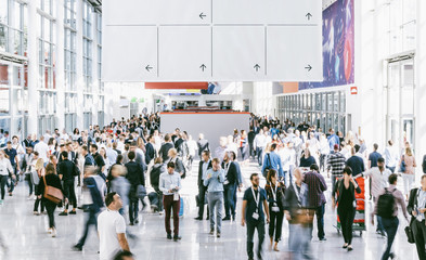 Crowd of people walking on a trade show in london