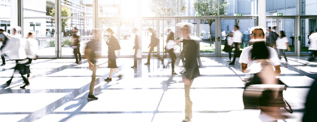 large crowd of anonymous blurred people at a trade fair