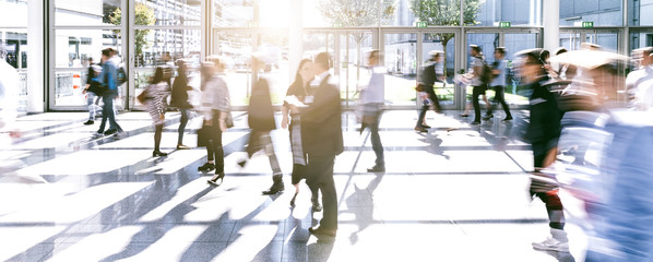 Crowd of anonymous people walking on a trade fair