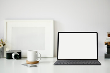 Minimal workspace with blank screen tablet.