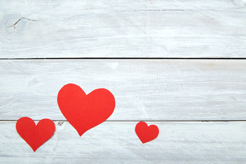 Red paper hearts on white wood Valentine's Day