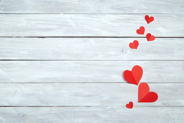 Red paper hearts on white wood Valentine's Day