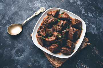 Mutton Liver fry or Kaleji masala, popular Non vegetarian recipe from India and Pakistan. served dry or with curry in a bowl, karahi or plate