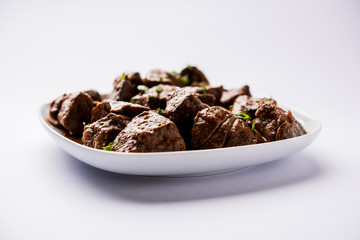 Mutton Liver fry or Kaleji masala, popular Non vegetarian recipe from India and Pakistan. served dry or with curry in a bowl, karahi or plate