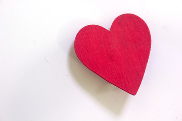 Red heart shape made of wood on a white background, leaving space blank.