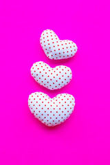 Red dots on white heart shape, Valentine's hearts on pink background, Top view