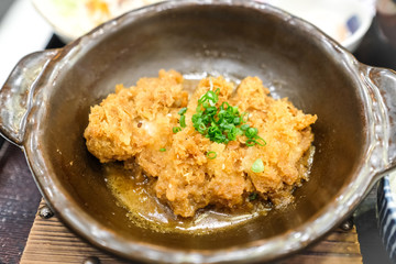 Crispy fried pork or Tonkatsu with miso sauce in the bowl. Japanese food.