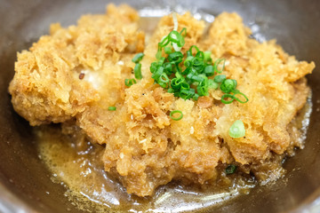 Crispy fried pork or Tonkatsu with miso sauce in the bowl. Japanese food.
