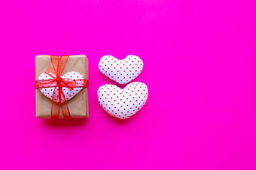 Fototapeta na wymiar Valentine's heart with gift box on pink background.