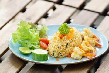 Shrimp fried rice serving with fresh vegetable on white  plate