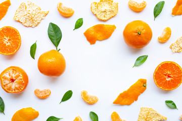 Orange fruits and green leaves on a white background.