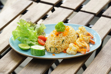 Shrimp fried rice serving with fresh vegetable on white  plate