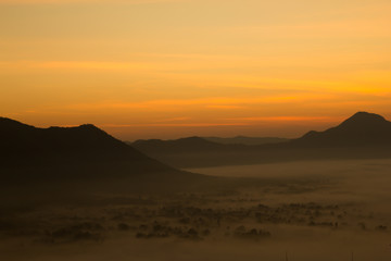 Fototapeta na wymiar Beautiful sky sunrise. Mountain layer in morning sun ray and winter fog.