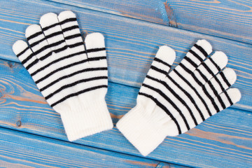 Pair of striped womanly gloves for autumn or winter