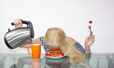 Sleepy young woman had breakfast and put her head in a plate, fell asleep in a plate. Pours water...