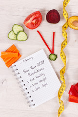 Fototapeta na wymiar Clock made of fruits and vegetables showing time of 23 hours 55 minutes and new year resolutions for 2019