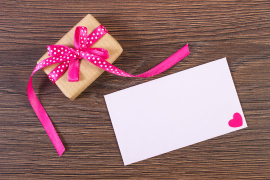 Gift with ribbon and love letter for Valentines Day, place for text on paper