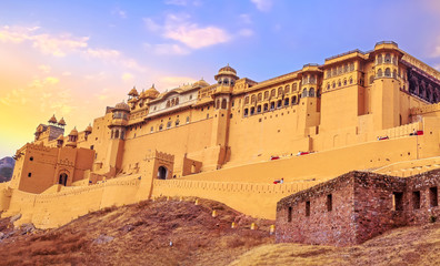Fototapeta premium Amer Fort Jaipur Rajasthan exterior architecture with moody sunset sky. A UNESCO World Heritage site.