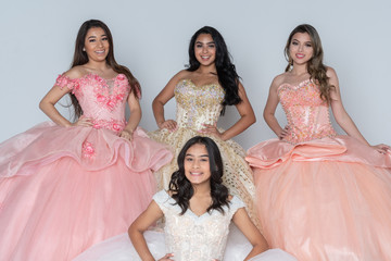 Four Hispanic Girls In Quinceanera Dresses © Rob