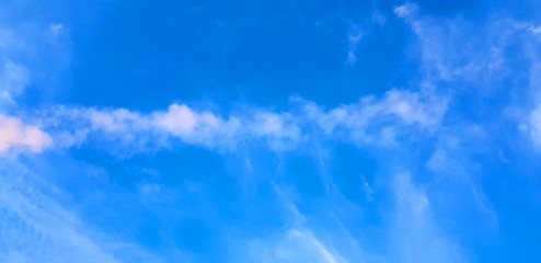 blue sky background with tiny clouds.