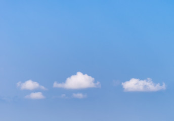 Blue sky with small white clouds.