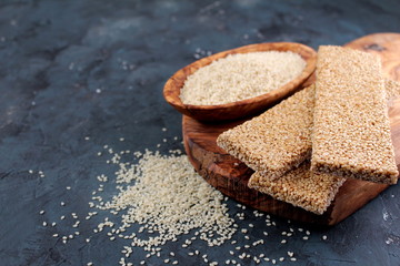 Honey bars with sesame seeds on wooden background. Top view with copy space.