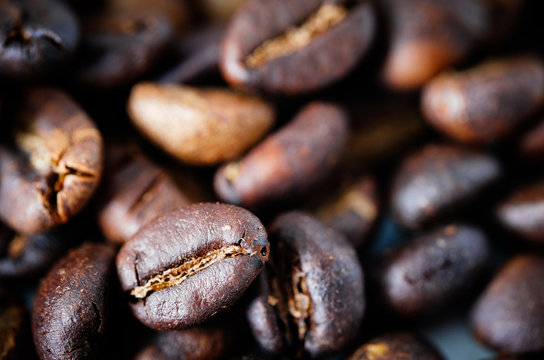 Coffee beans background texture with copy space for text. Royalty high-quality free stock macro photo image of roasted black coffee beans, coffee beans background. Close-up or macro photo coffee bean