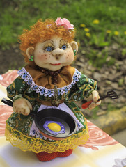 Soft handmade doll with a frying pan