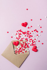 Multicolor sweets sugar candy hearts fly out of craft paper postal envelope. Happy Valentine's dayconcept. Festive background